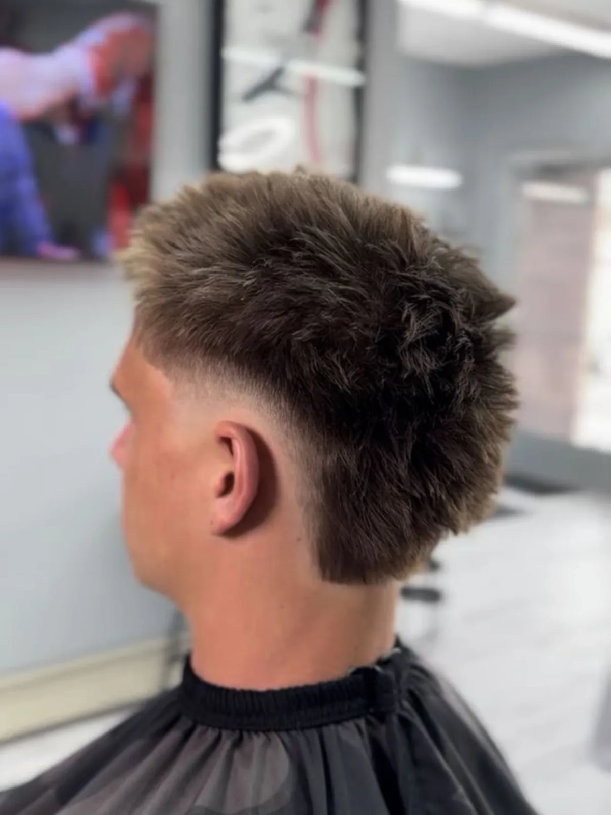 Spiky textured mullet with a low taper fade