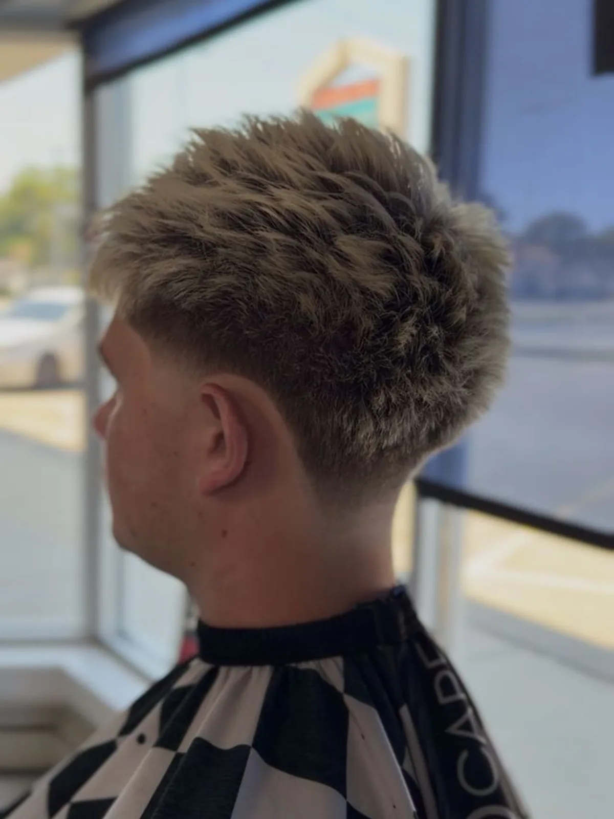 Textured crop haircut with a low taper fade