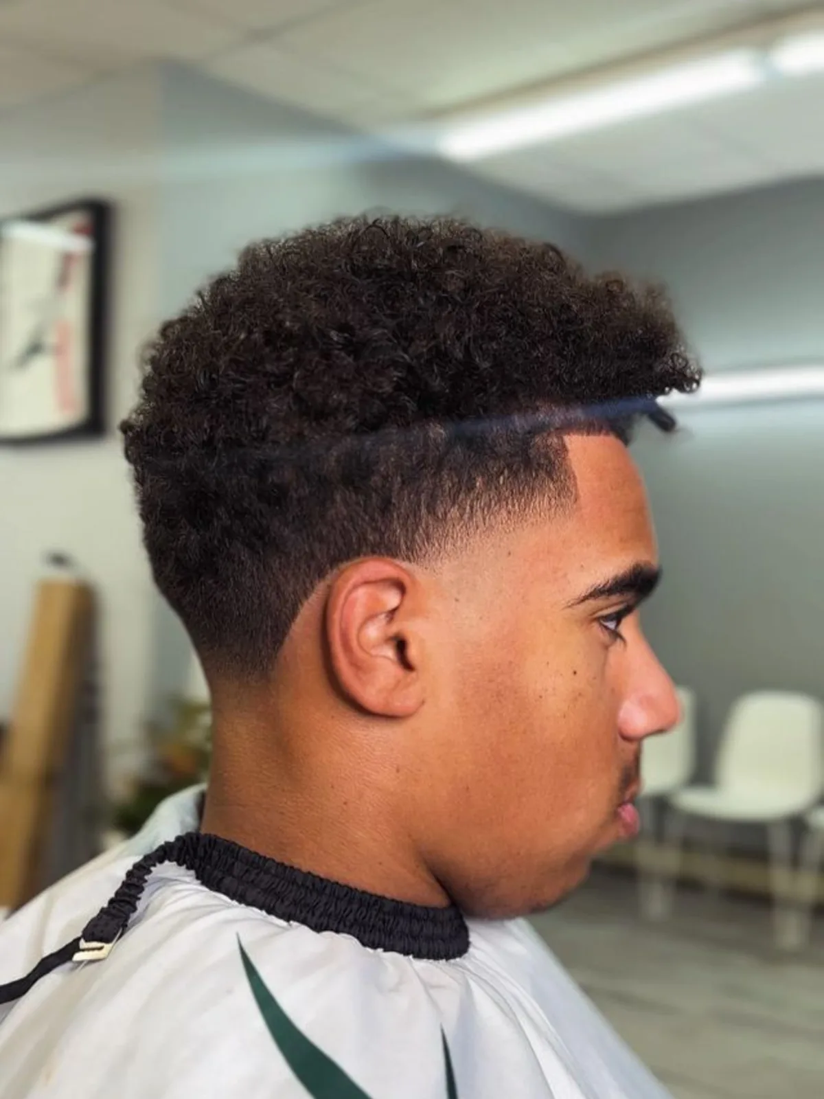 Curly top with a drop fade and sharp lineup