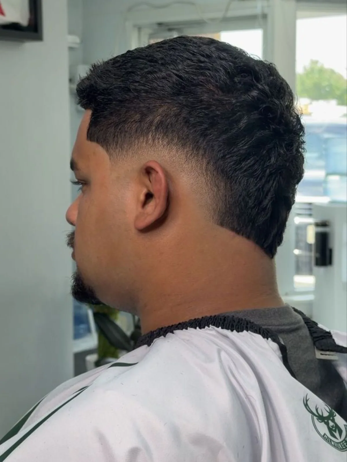 Dark textured mullet with a low taper fade