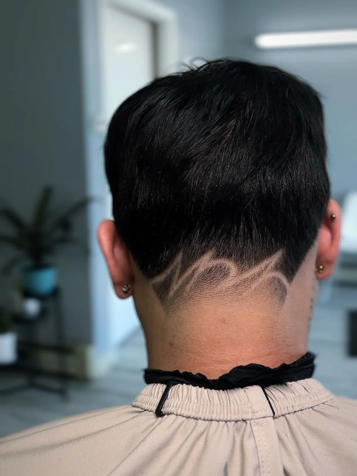 Freestyle hair design etched above a tapered neckline