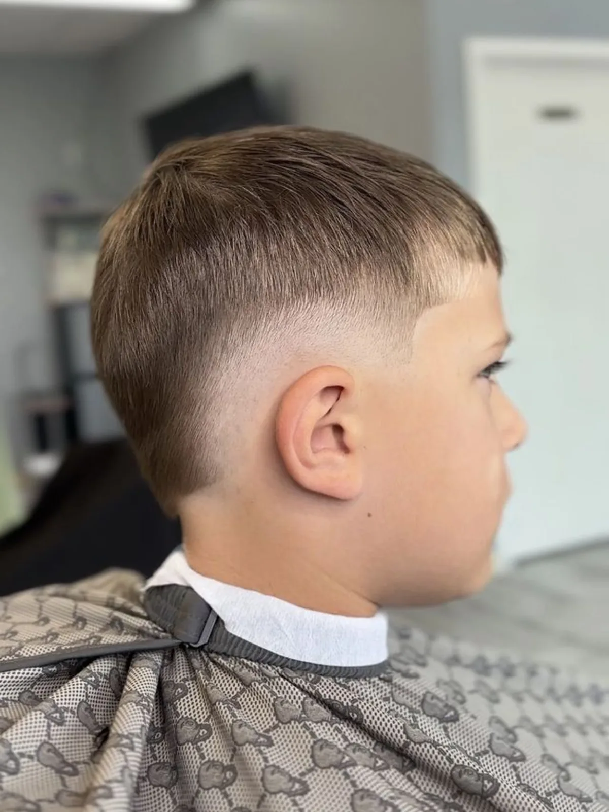 Kids crop with a straight fringe and mid skin fade