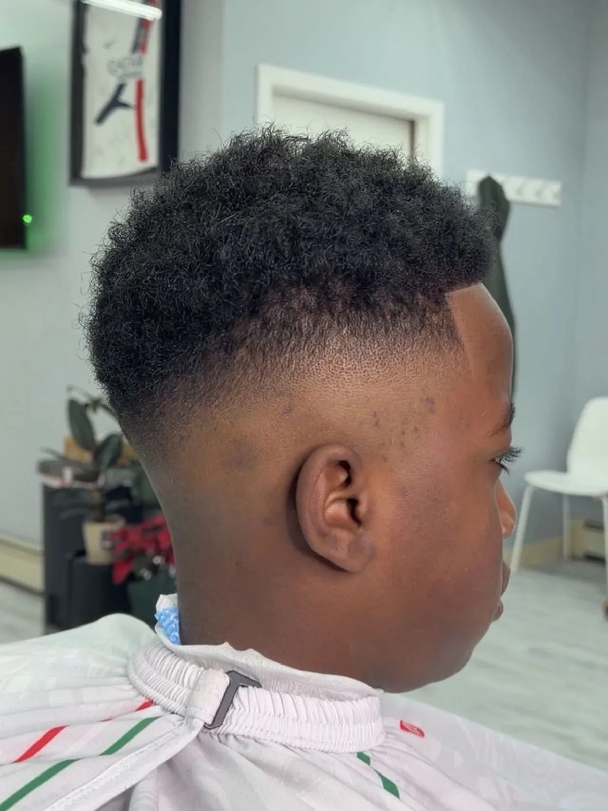 Kids curly afro top with a mid fade and lineup