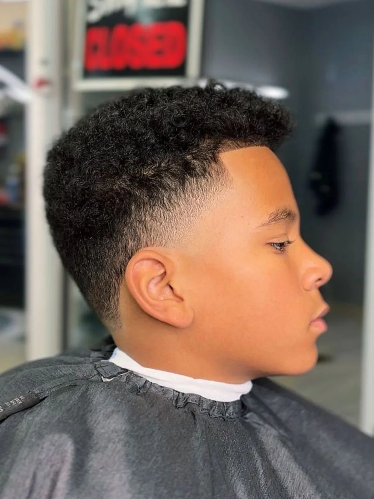 Kids curly top with a low fade and sharp lineup