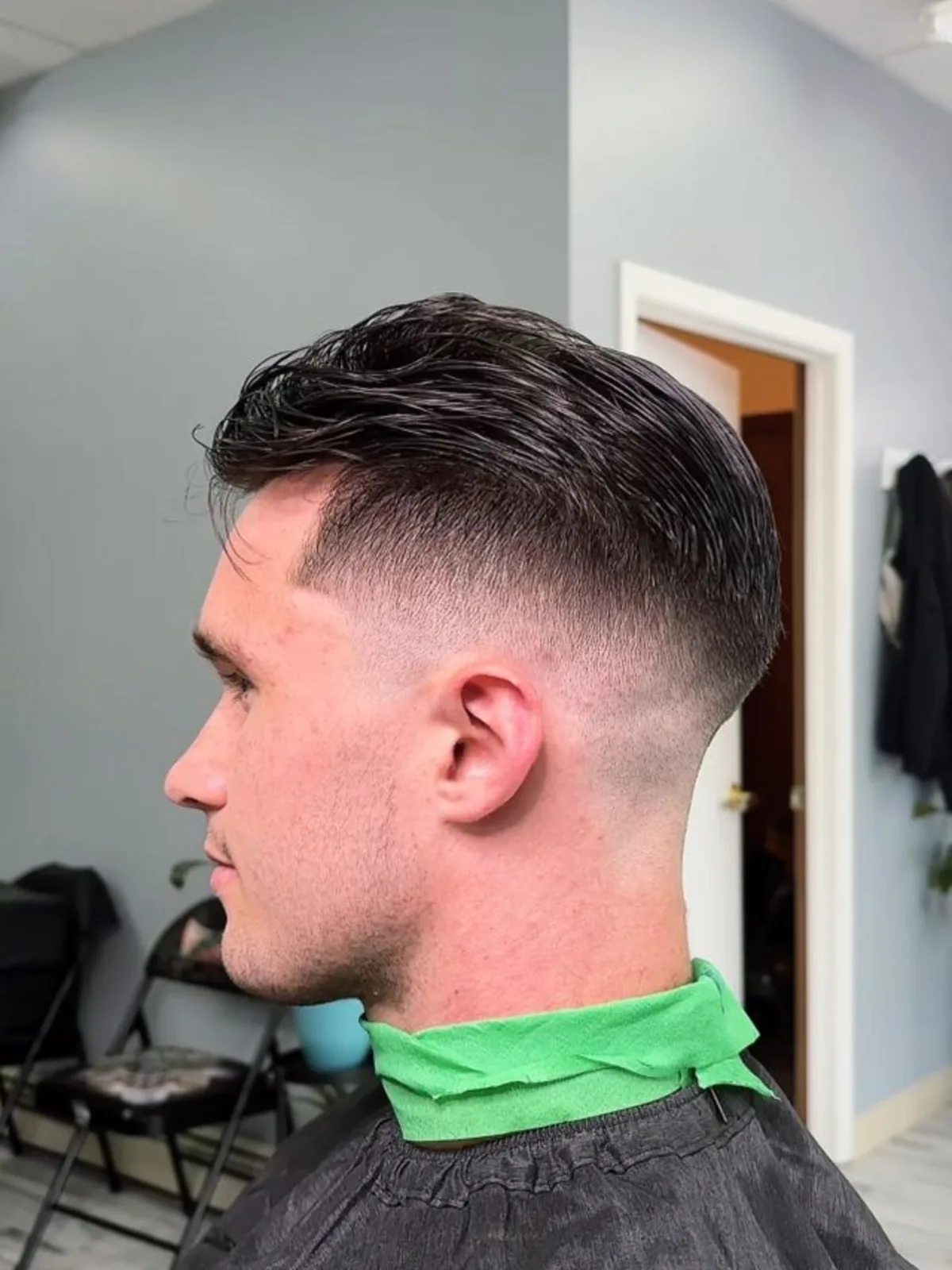 Slicked-back medium top with a mid drop fade