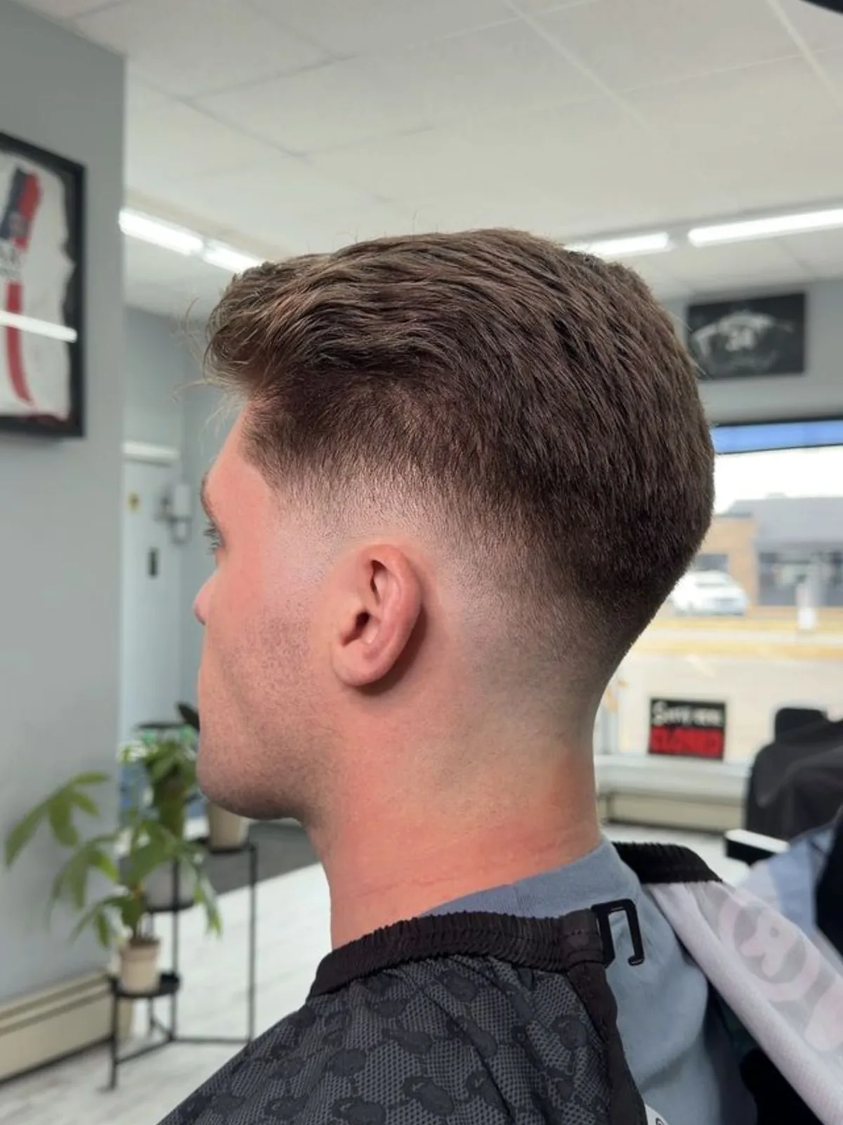 Textured brushed-up quiff with a mid fade