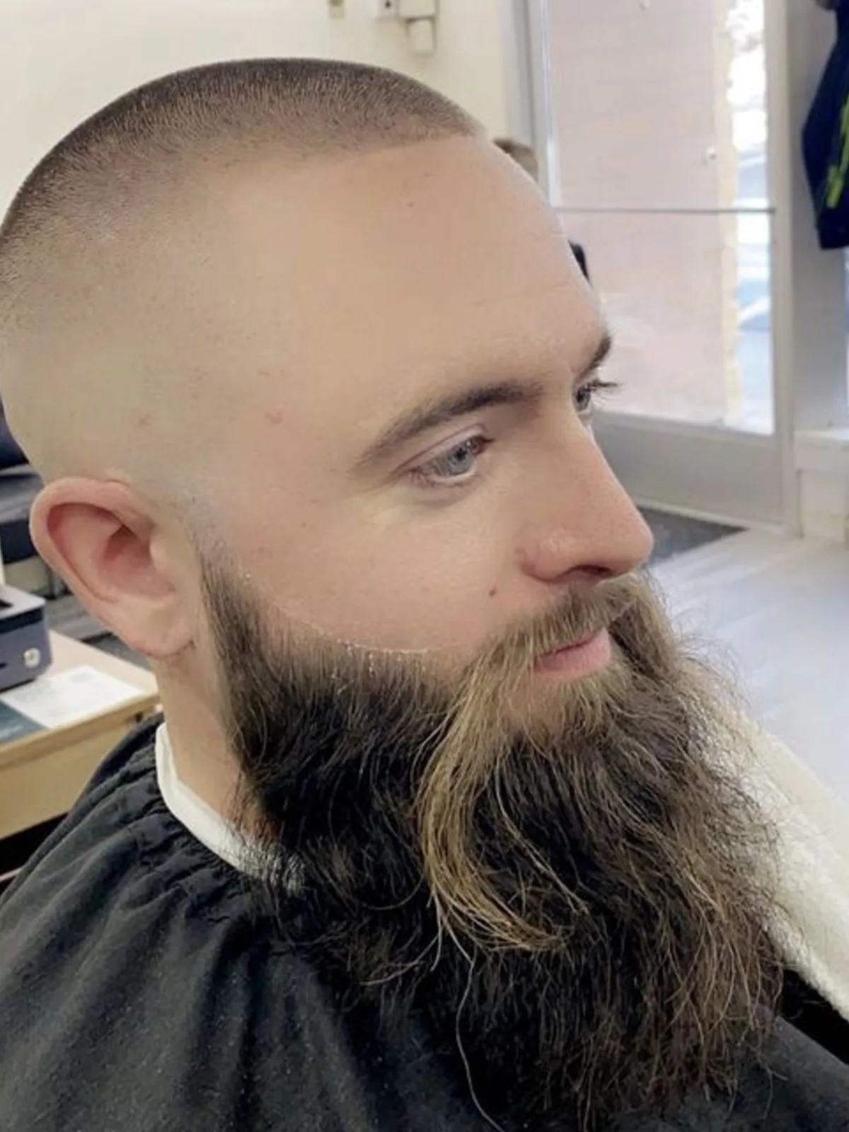 Buzz cut with a skin fade and long full beard