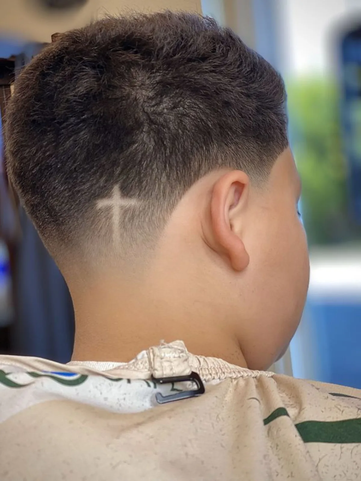 Cross hair design etched into a low taper fade