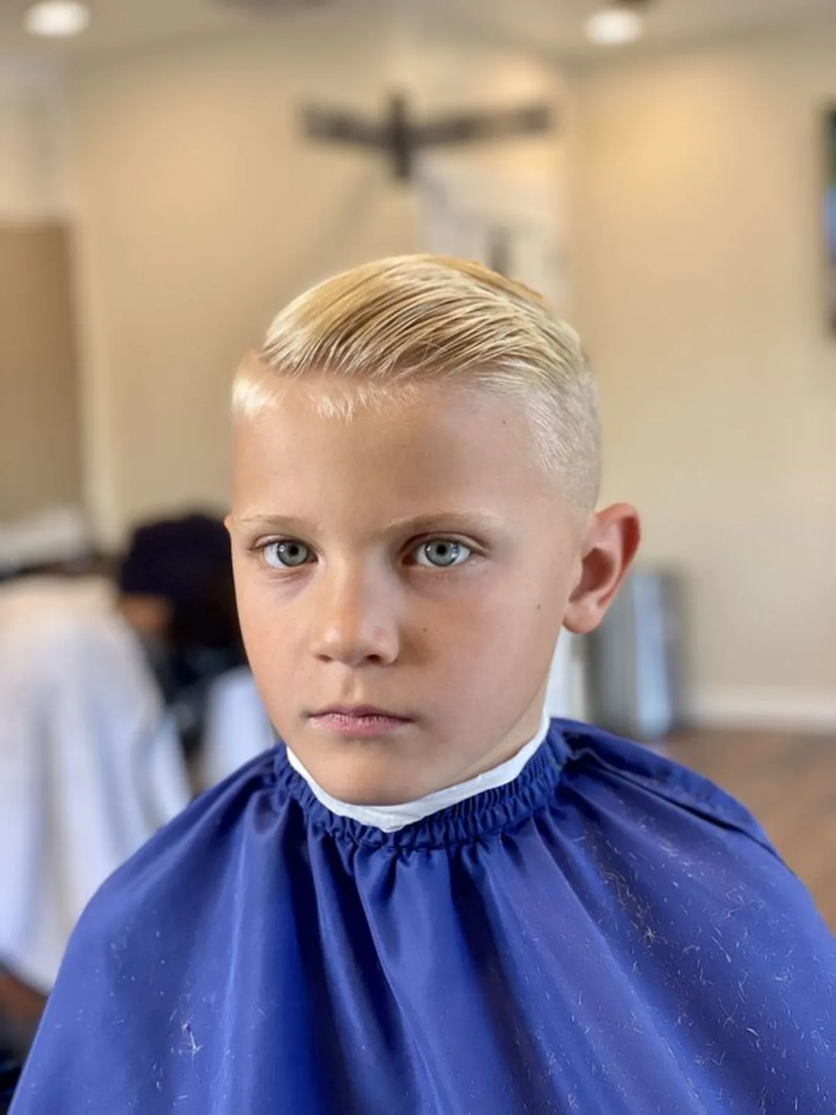Kids blonde slicked comb over with a skin fade