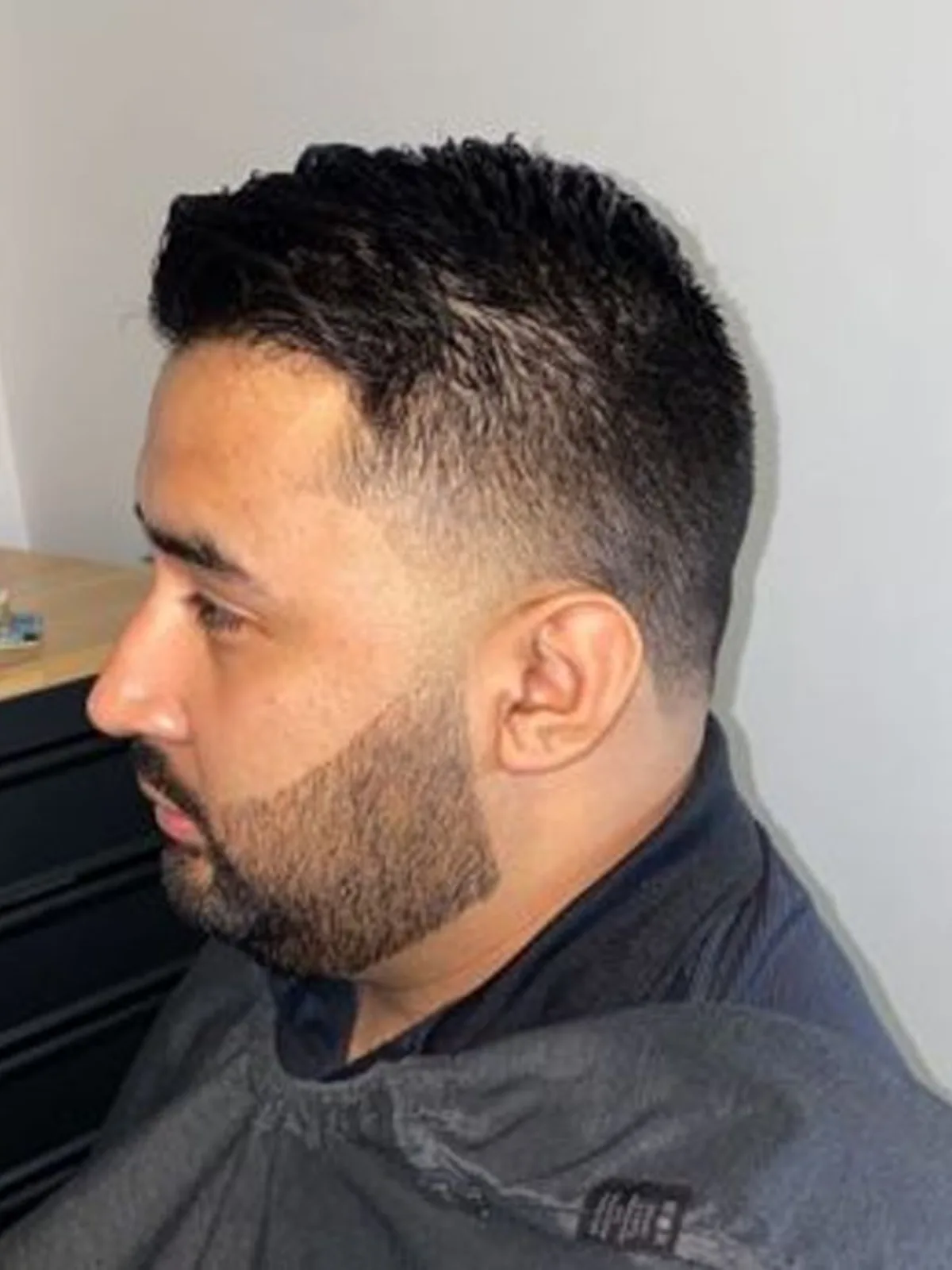 Short textured cut with a taper fade and beard lineup