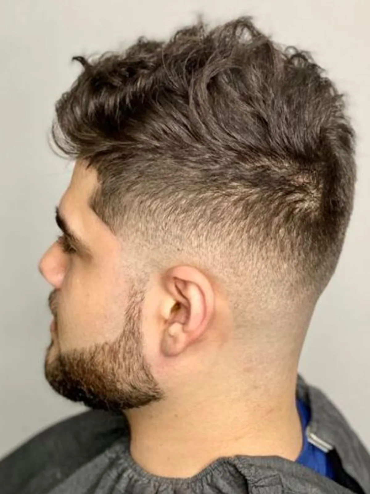 Textured quiff with a mid skin fade and beard