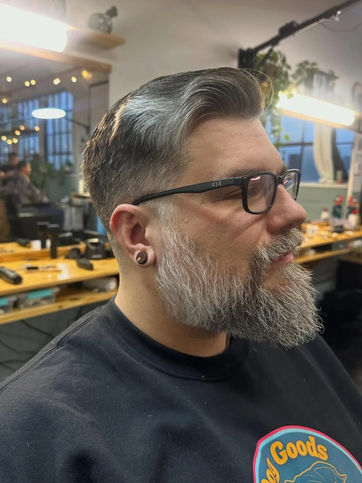 Gray swept-back cut with a long full beard