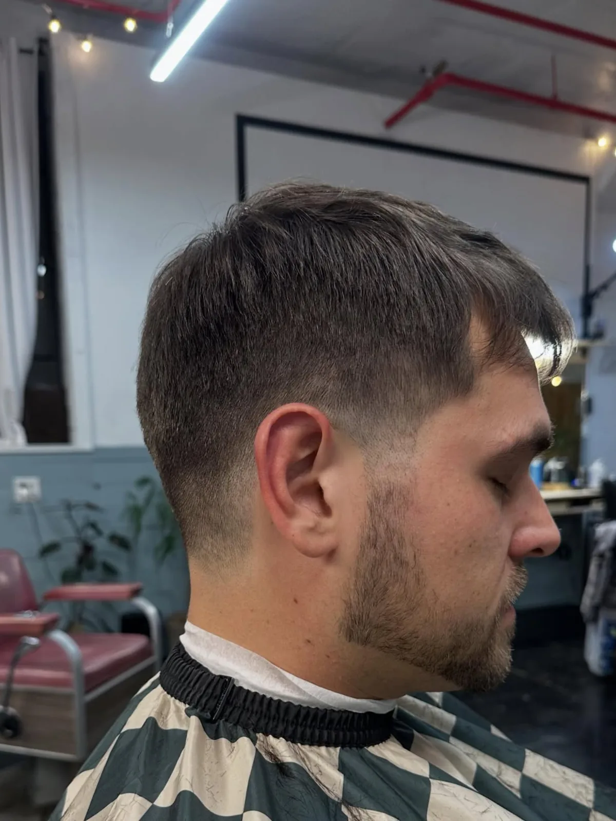 Dark textured fringe crop with a low taper and beard