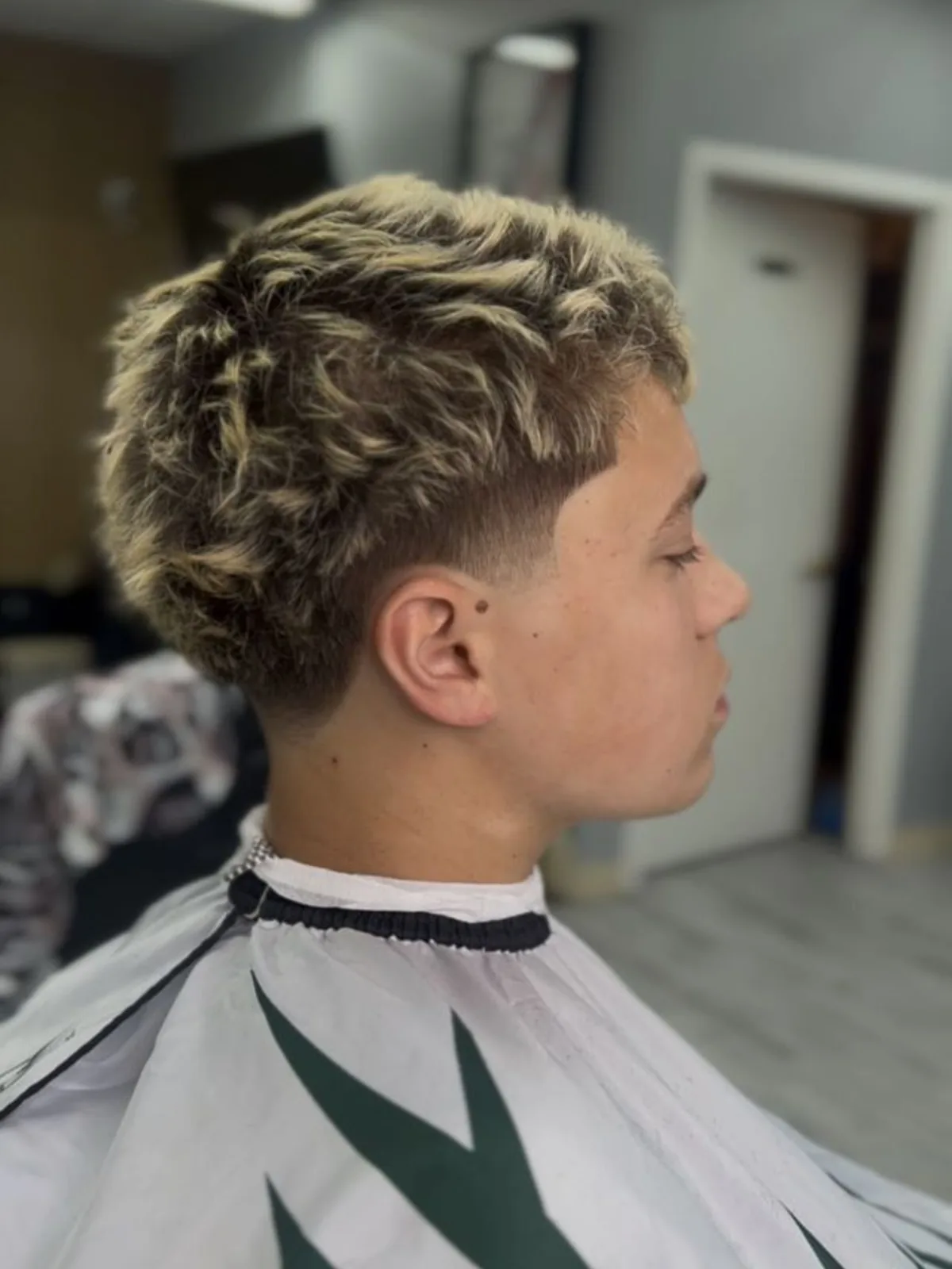 Frosted curly fringe with a low taper fade